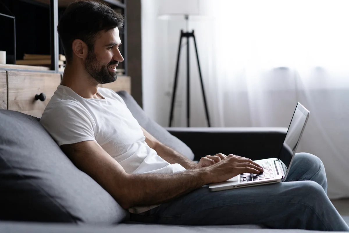 Adult using a laptop for a private online conversation