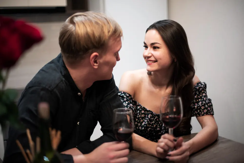 Adult woman starting a conversation with a mature man over dinner